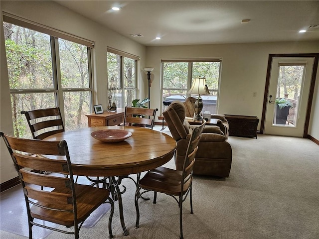 dining space featuring light colored carpet