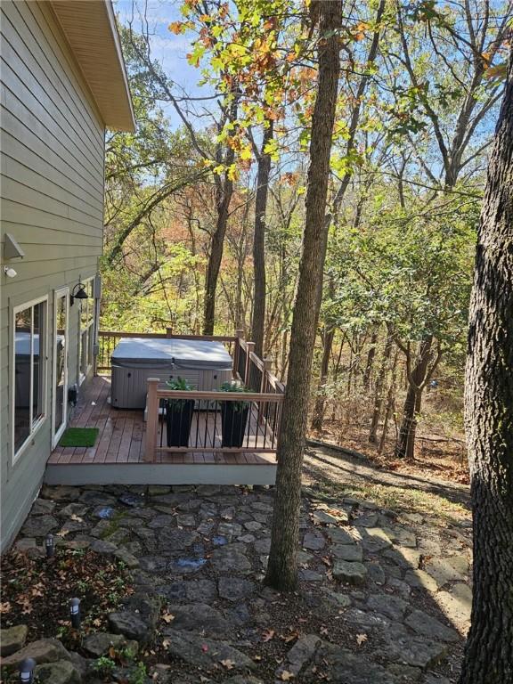 view of yard featuring a deck and a hot tub