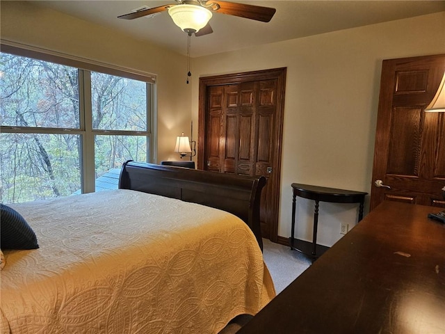 bedroom featuring ceiling fan, a closet, and carpet floors