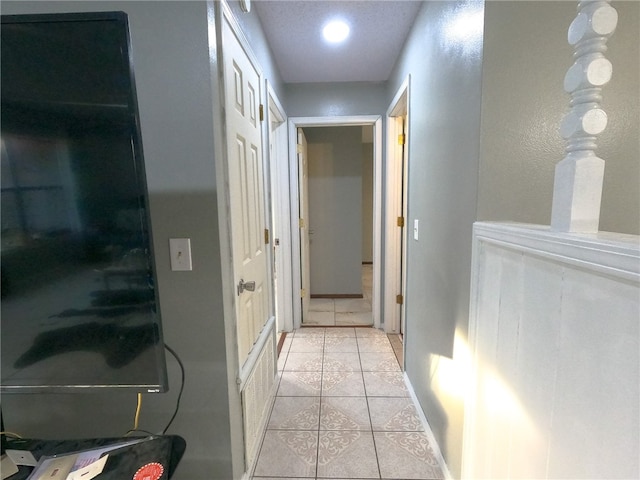 hall featuring light tile patterned floors