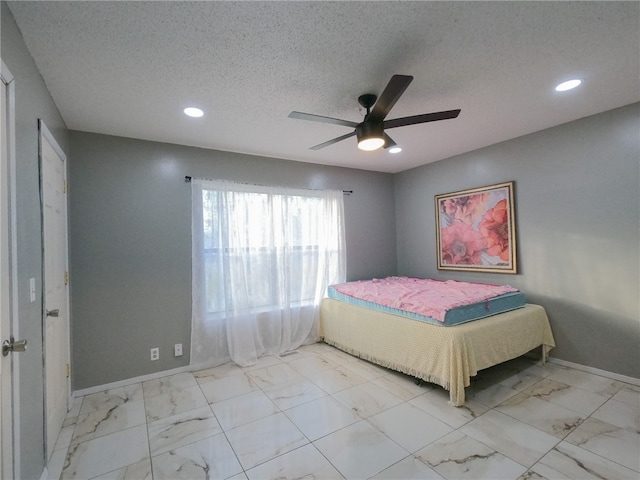 unfurnished bedroom featuring ceiling fan and a textured ceiling