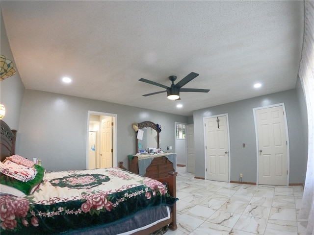 bedroom with ceiling fan and a textured ceiling