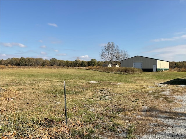 view of yard featuring an outbuilding and a rural view