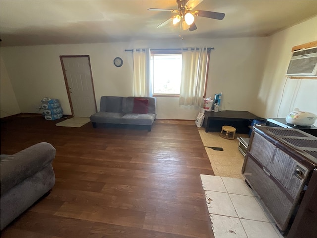 living room with a wall unit AC, ceiling fan, and light wood-type flooring