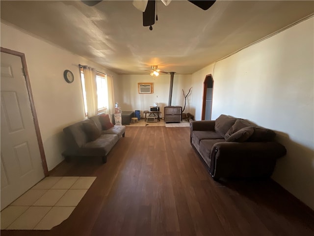 living room with hardwood / wood-style floors, ceiling fan, and an AC wall unit