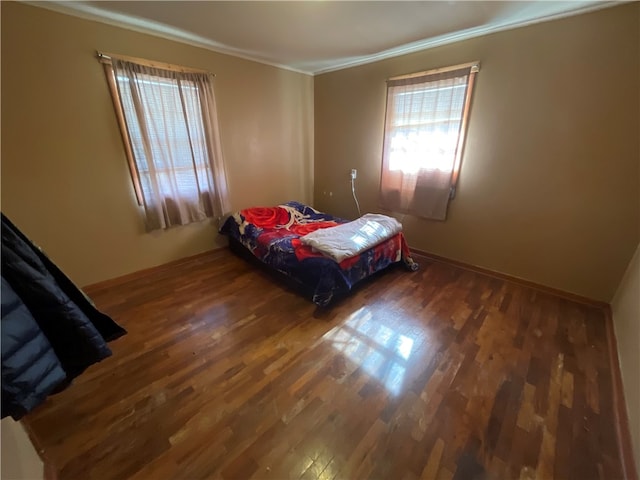 bedroom featuring ornamental molding and dark hardwood / wood-style floors