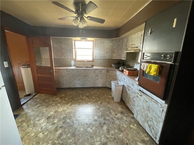 kitchen with sink, ceiling fan, and wall oven