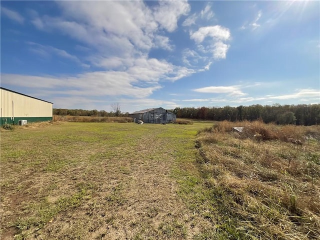 1054 N Oaks Rd, Tahlequah, OK 74464 - view of green lawn featuring an outbuilding and a view of countryside