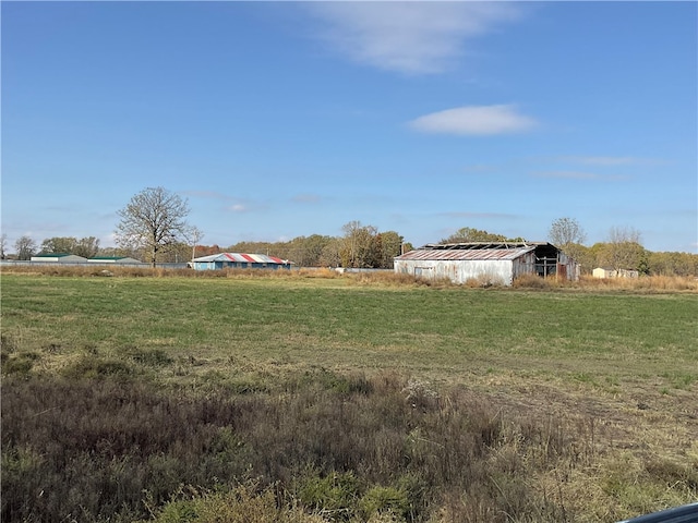 view of yard with a rural view and an outbuilding