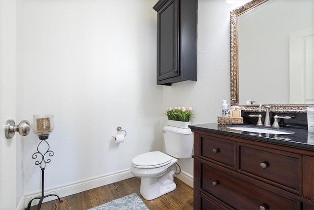 1303 NW Hermanus St, Bentonville, AR 72712 - bathroom featuring toilet, baseboards, wood finished floors, and vanity