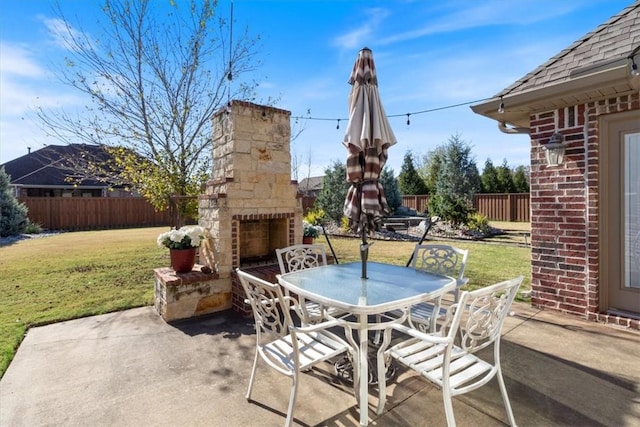 1303 NW Hermanus St, Bentonville, AR 72712 - view of patio / terrace featuring an outdoor stone fireplace, fence, and outdoor dining space