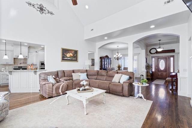 1303 NW Hermanus St, Bentonville, AR 72712 - living room featuring visible vents, dark wood-style floors, recessed lighting, a chandelier, and arched walkways