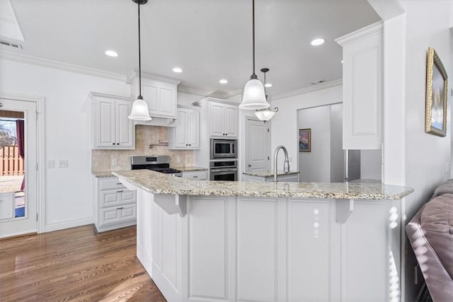 1303 NW Hermanus St, Bentonville, AR 72712 - kitchen featuring decorative backsplash, visible vents, appliances with stainless steel finishes, white cabinets, and ornamental molding
