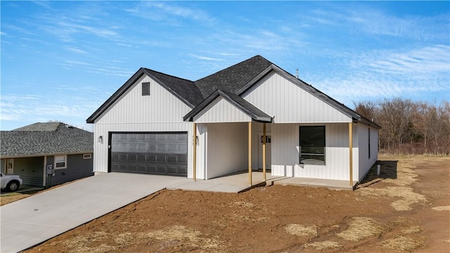 modern farmhouse with a porch and a garage