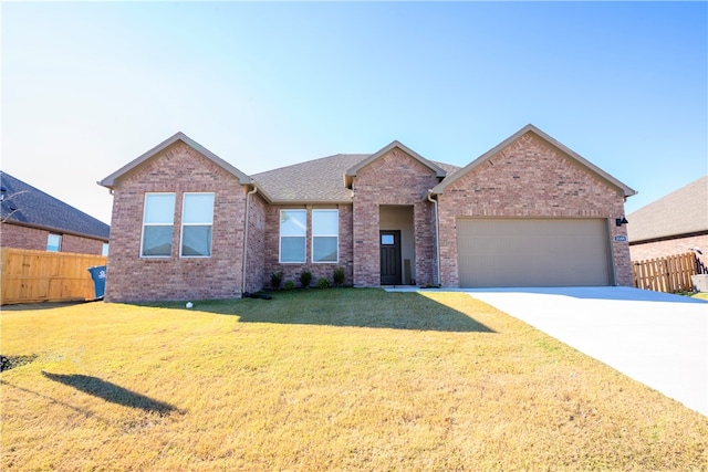 view of front of house featuring a garage and a front yard