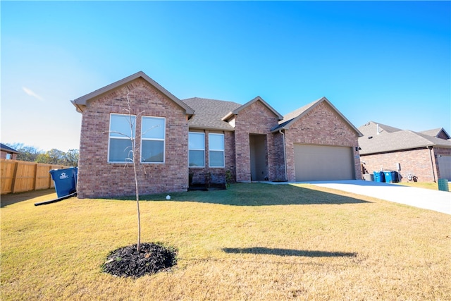 view of front of property featuring a front lawn and a garage