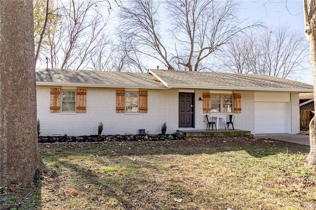 ranch-style house featuring a front yard, a garage, and covered porch