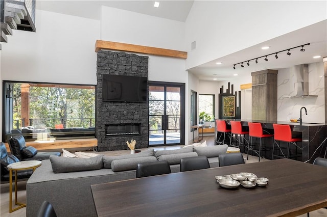 514 N Vinson Ave, Fayetteville, AR 72701 - living area with rail lighting, a towering ceiling, and a fireplace