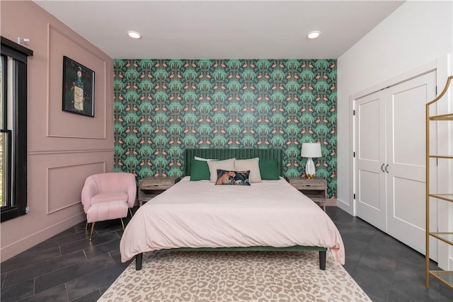 514 N Vinson Ave, Fayetteville, AR 72701 - bedroom featuring an accent wall, wallpapered walls, baseboards, recessed lighting, and tile patterned floors
