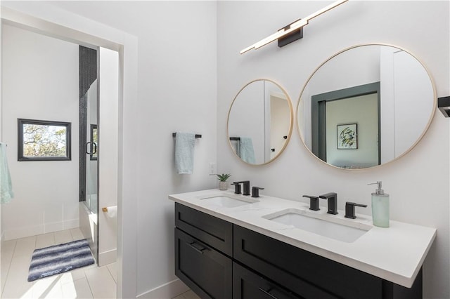 514 N Vinson Ave, Fayetteville, AR 72701 - bathroom with tile patterned floors, double vanity, enclosed tub / shower combo, and baseboards