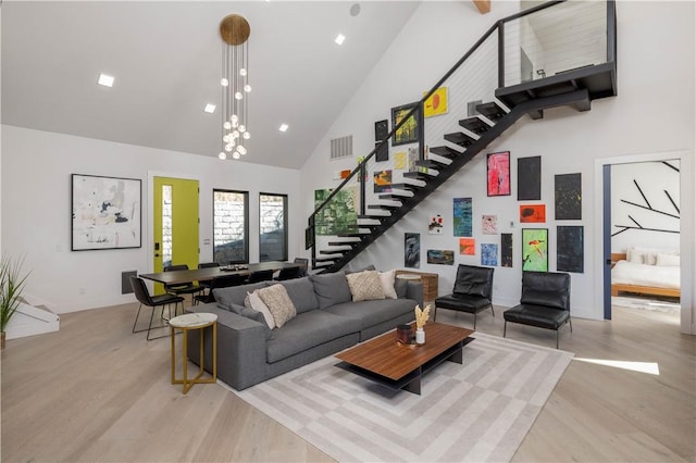 514 N Vinson Ave, Fayetteville, AR 72701 - living room with high vaulted ceiling, stairway, light wood-style flooring, and baseboards