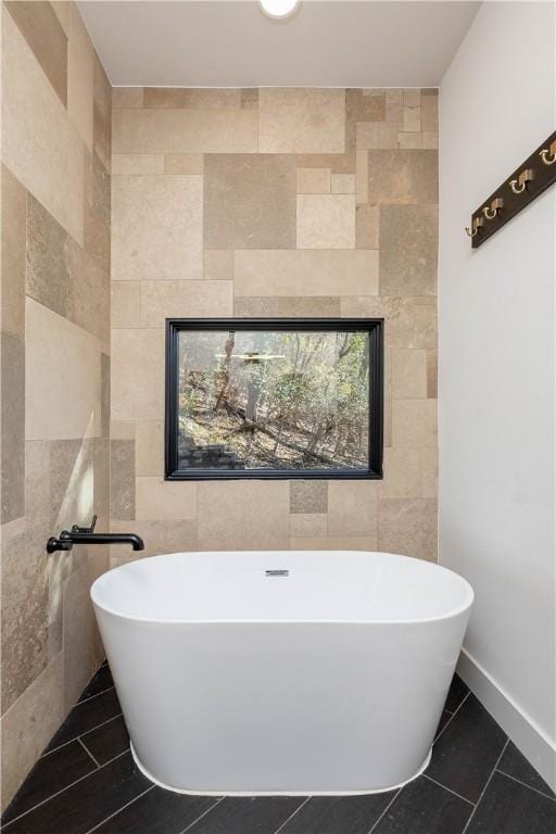 514 N Vinson Ave, Fayetteville, AR 72701 - full bath featuring tile walls, a freestanding bath, and tile patterned flooring