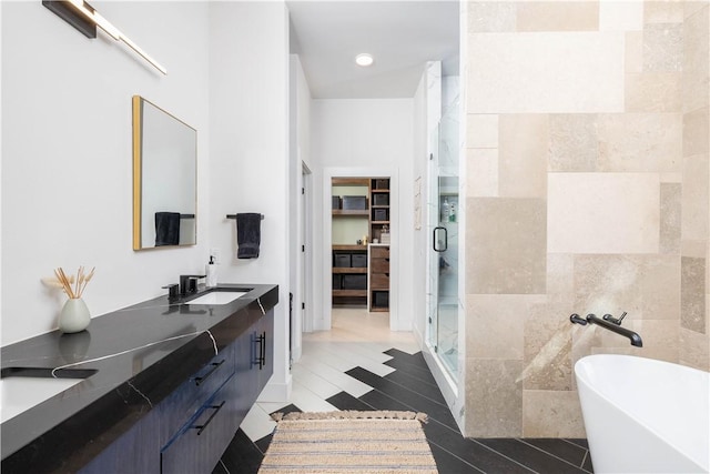 514 N Vinson Ave, Fayetteville, AR 72701 - full bath with a shower stall, a soaking tub, double vanity, a walk in closet, and tile patterned floors
