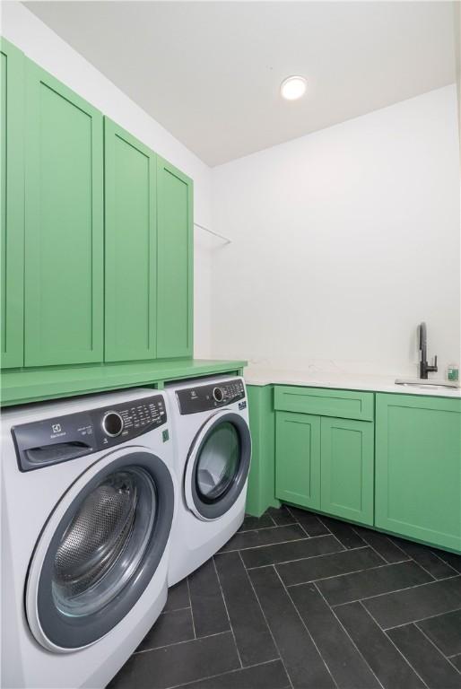 514 N Vinson Ave, Fayetteville, AR 72701 - clothes washing area featuring washing machine and dryer, cabinet space, and dark tile patterned floors