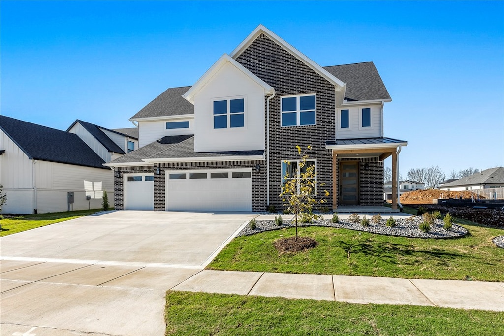 view of front of property featuring a front lawn and a garage