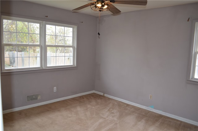 carpeted empty room featuring ceiling fan