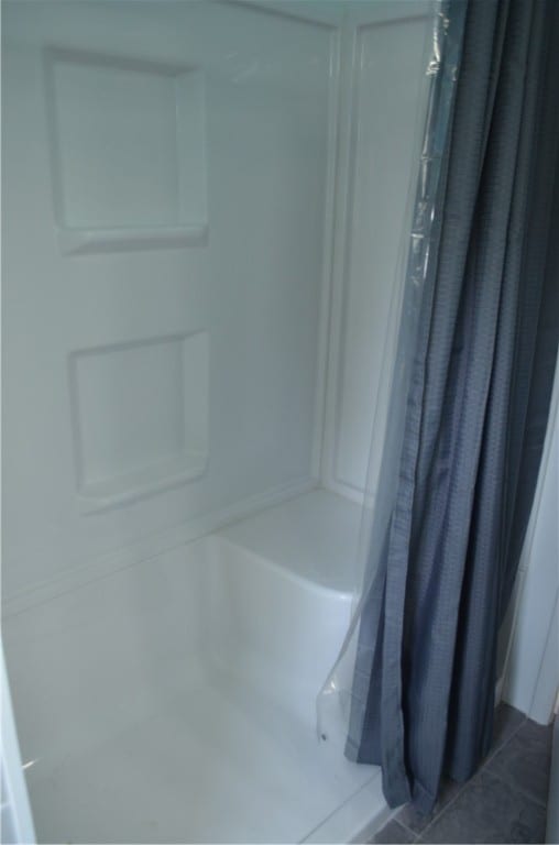 bathroom featuring tile patterned flooring and curtained shower