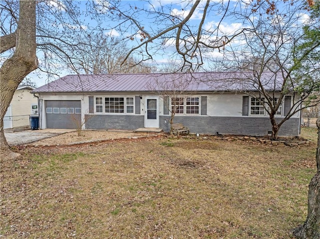 ranch-style house featuring a garage, brick siding, a front yard, and driveway