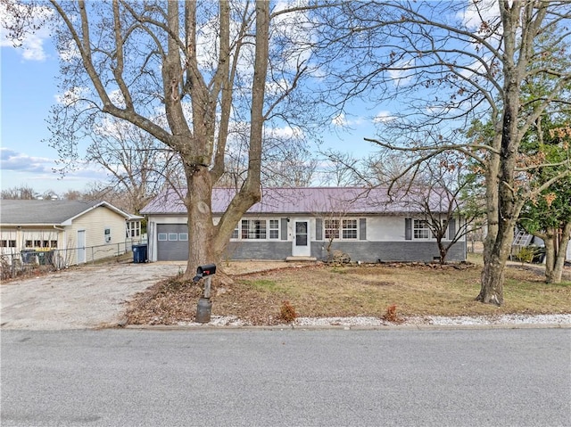 ranch-style house with a front lawn, aphalt driveway, fence, a garage, and stucco siding