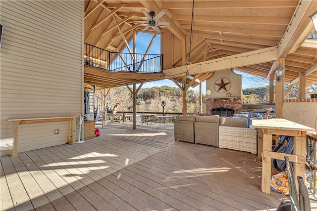 deck featuring an outdoor living space with a fireplace, a mountain view, and ceiling fan