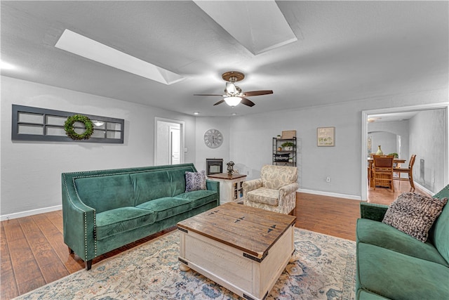 living room with hardwood / wood-style flooring and ceiling fan