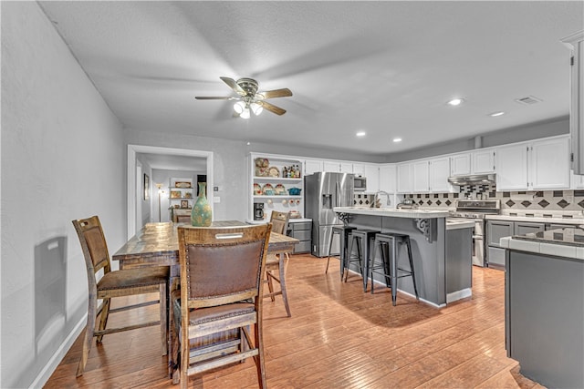 dining space featuring ceiling fan and light hardwood / wood-style floors