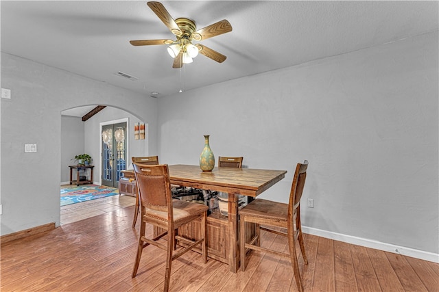 dining area with french doors, light hardwood / wood-style flooring, and ceiling fan