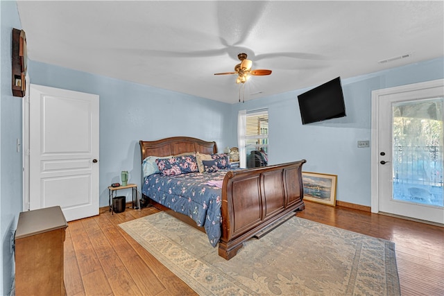 bedroom with access to exterior, light hardwood / wood-style floors, and ceiling fan