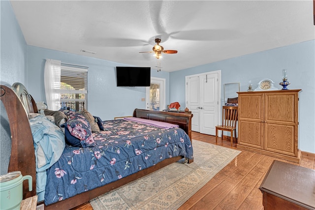 bedroom with ceiling fan and light hardwood / wood-style floors