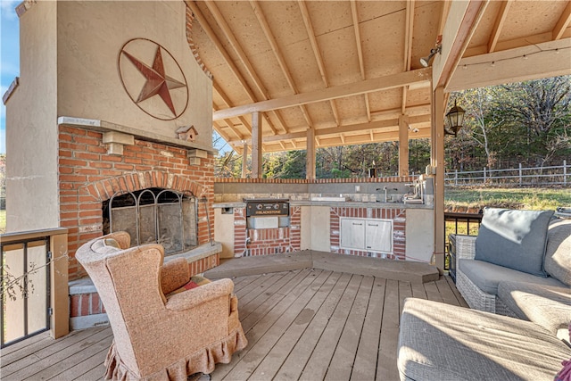 deck with sink, exterior kitchen, and a grill