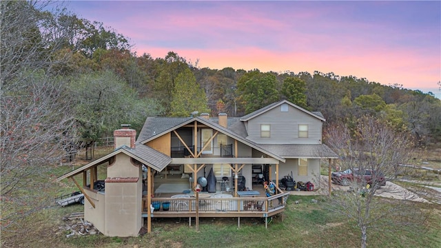 view of back house at dusk