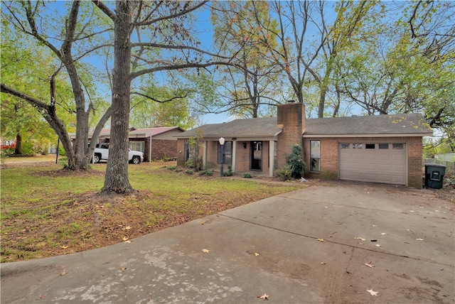 single story home featuring a garage and a front lawn