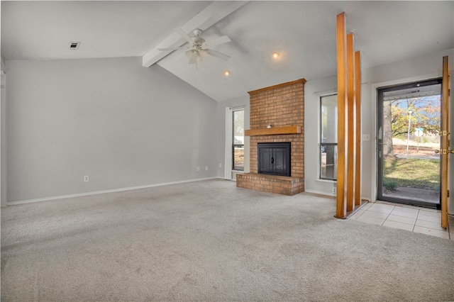 unfurnished living room featuring a brick fireplace, ceiling fan, vaulted ceiling with beams, and light colored carpet