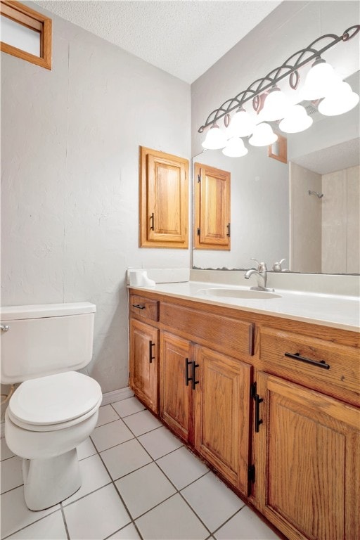 bathroom with vanity, a textured ceiling, tile patterned floors, and toilet