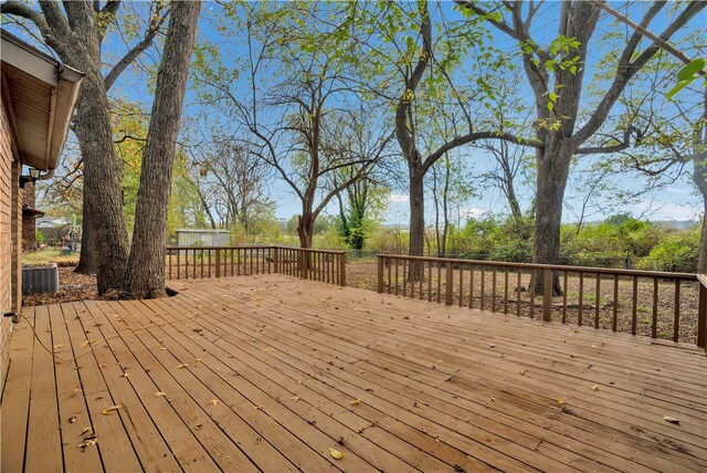 wooden terrace featuring cooling unit