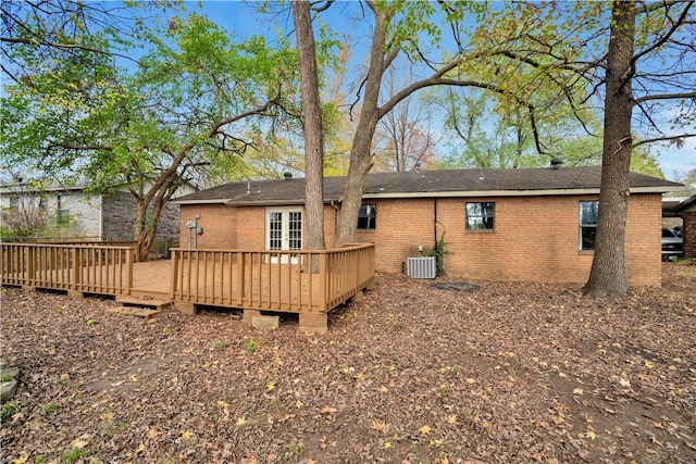 back of house with central air condition unit and a wooden deck