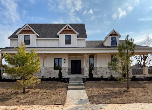 modern farmhouse style home with board and batten siding and stone siding