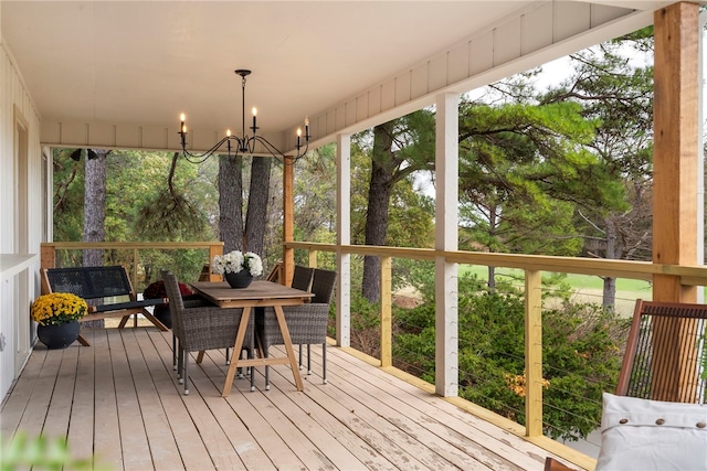 sunroom / solarium with a chandelier