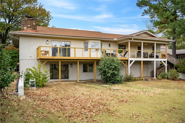 back of house with a lawn and a deck