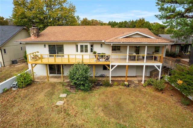 rear view of property featuring cooling unit, a patio, and a deck